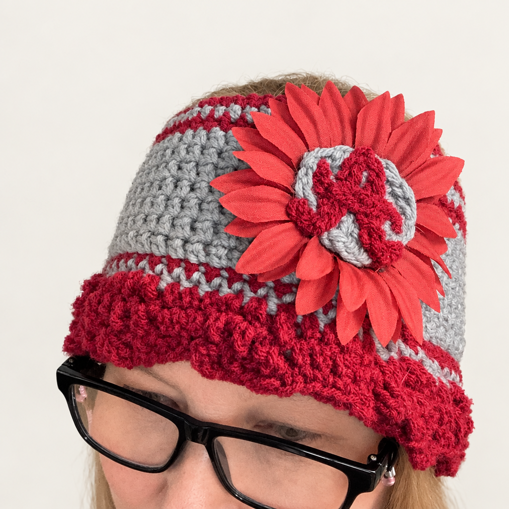 Alabama sunflower crochet headband in maroon and gray worn on a blonde wig, showing the fuzzy red A inside the fabric sunflower