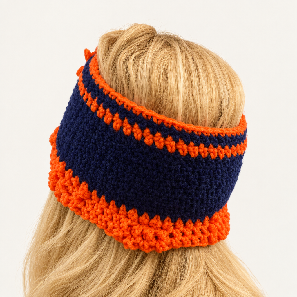Back view of Auburn sunflower crochet headband in navy blue with orange stitch trim and scalloped edging