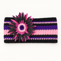 Handmade crocheted sunflower headband in black, purple, and pink stripes with a large fabric daisy accent