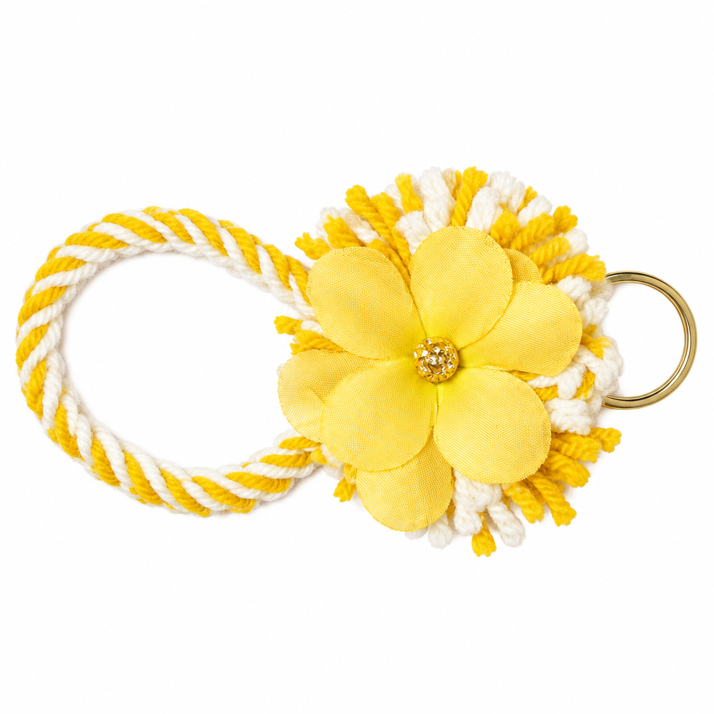 Yellow and white twisted yarn wristlet keychain with fluffy tassel and yellow satin flower